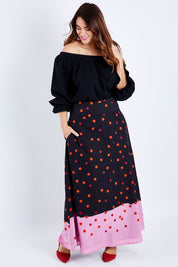 Model Laura wearing size 14 of the Rosie Maxi Skirt in colour Dots (Black), from the front, showing the whole outfit