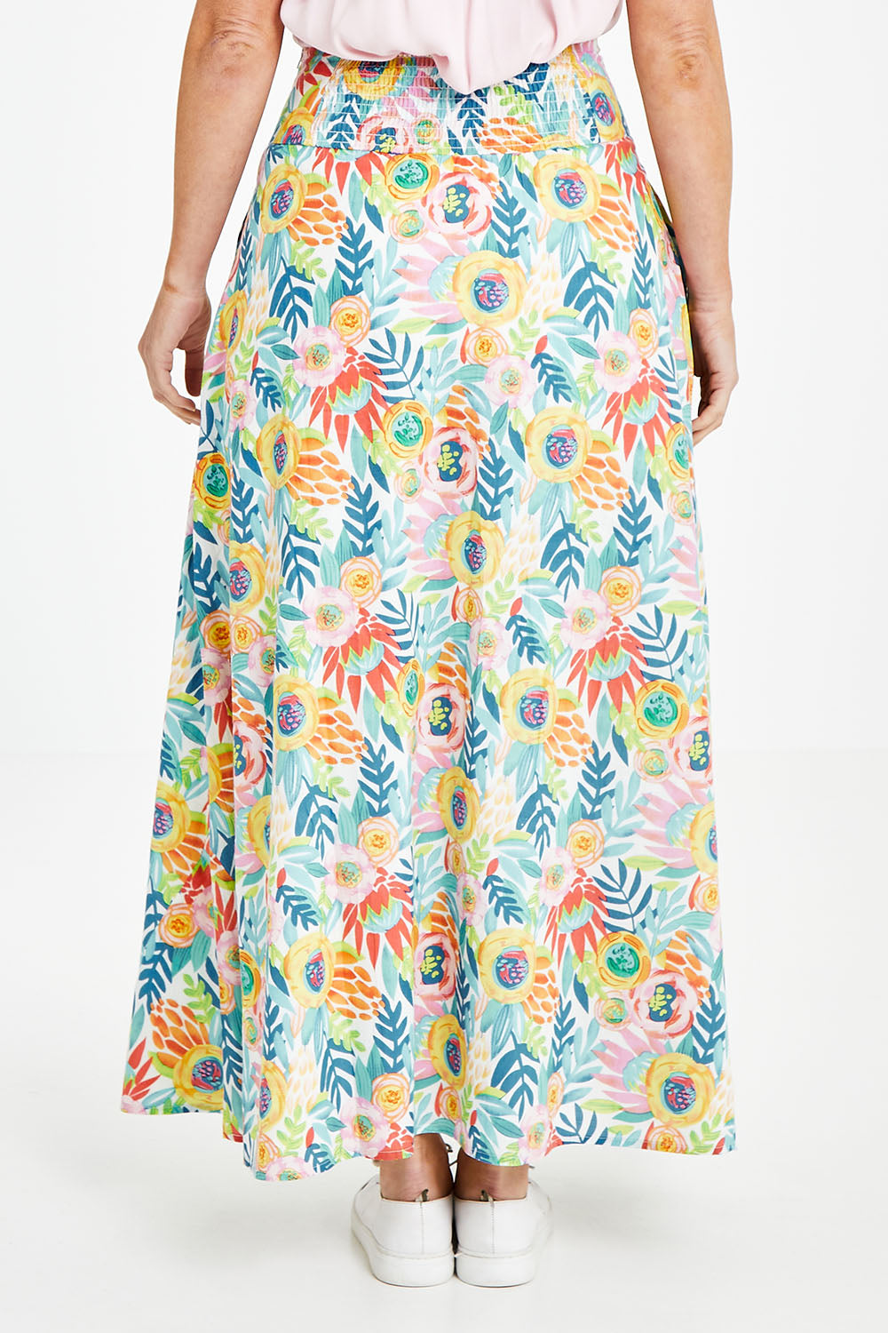 Model Laura wearing size 14 of the Rosie Maxi Skirt in colour Meadow (Blue), from the back