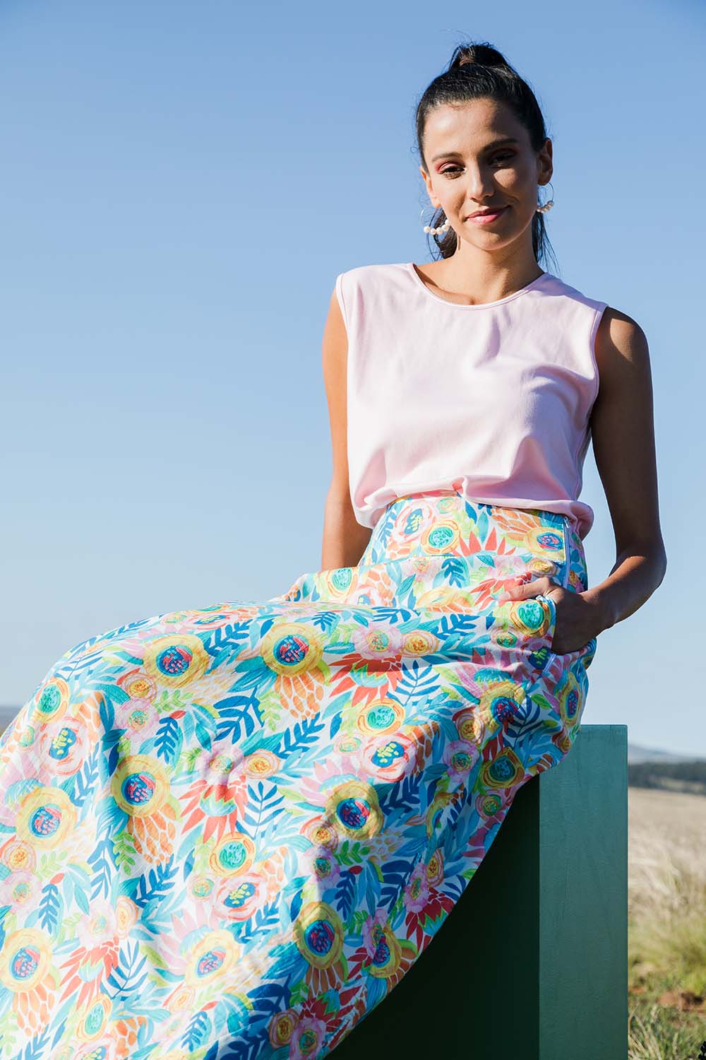 Model Vitoria wearing size 10 of the Rosie Maxi Skirt in colour Meadow (Blue), from the front, showing the whole outfit
