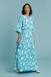 Model Natalie wearing size 10 of the Rosie Maxi Skirt in colour Gerbera (Blue), from the front, showing the whole outfit
