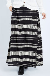Model Jess wearing size 14 of the Rosie Maxi Skirt in colour Sandstone (Black), from the front, cropped image