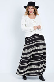 Model Jess wearing size 14 of the Rosie Maxi Skirt in colour Sandstone (Black), from the front, showing the whole outfit