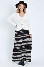 Model Jess wearing size 14 of the Rosie Maxi Skirt in colour Sandstone (Black), from the front, showing the whole outfit