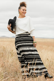 Model Lala wearing size 10 of the Rosie Maxi Skirt in colour Sandstone (Black), from the front, showing the whole outfit