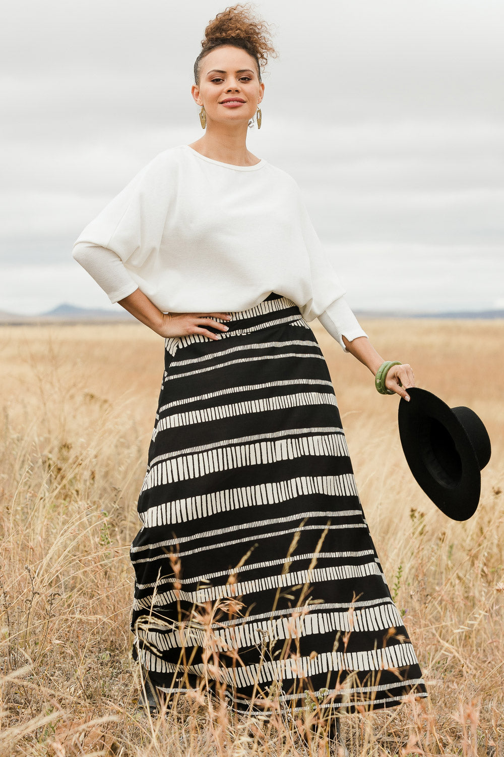 Model Lala wearing size 10 of the Rosie Maxi Skirt in colour Sandstone (Black), from the front, showing the whole outfit