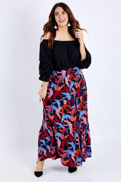Model Laura wearing size 14 of the Mallory Tier Skirt in colour Flock (Black), from the front, showing the whole outfit