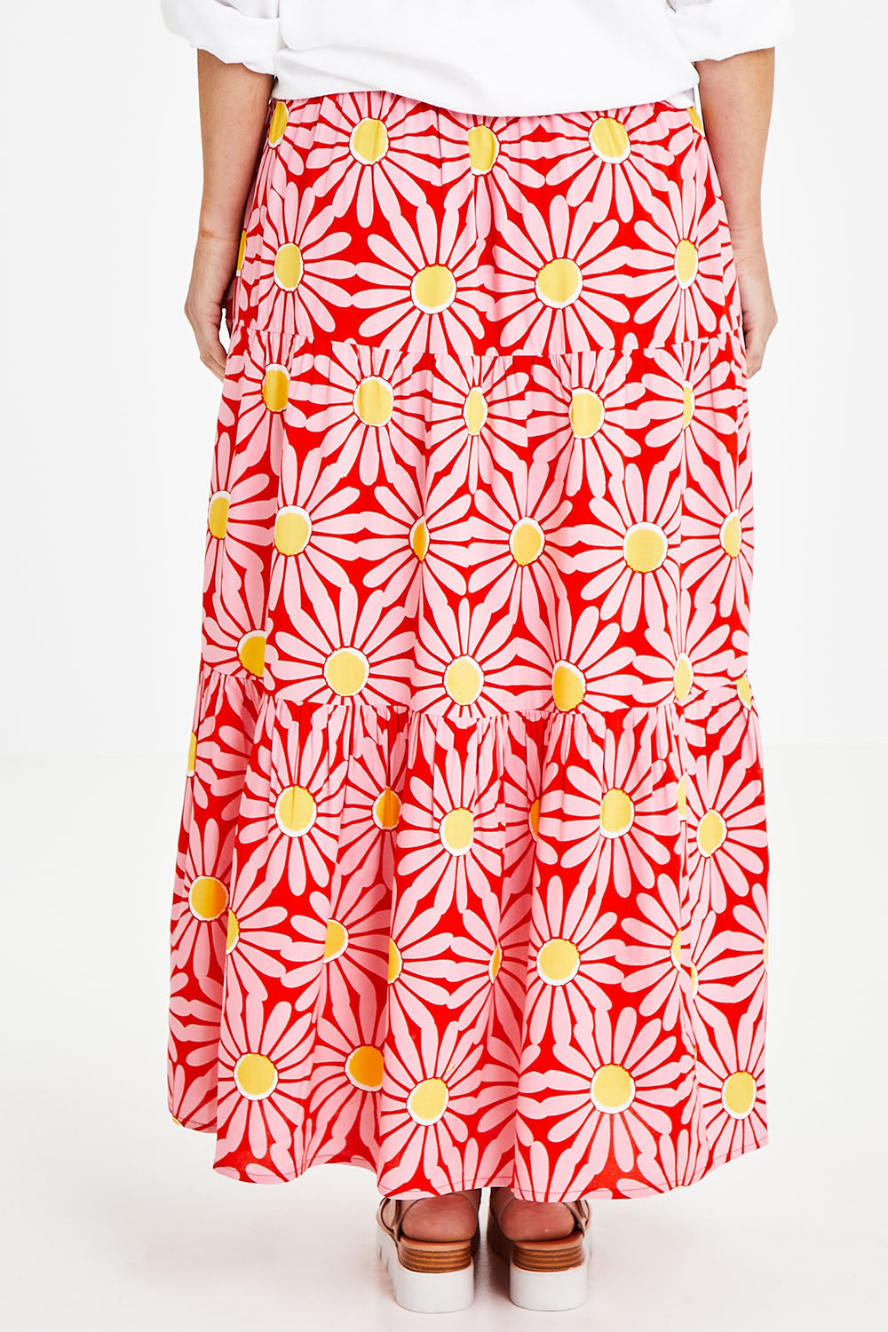 Model Laura wearing size 14 of the Mallory Tier Skirt in colour Pinkdaisy (Pink), from the back