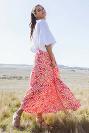 Model Vitoria wearing size 10 of the Mallory Tier Skirt in colour Pinkdaisy (Pink), from the front, showing the whole outfit
