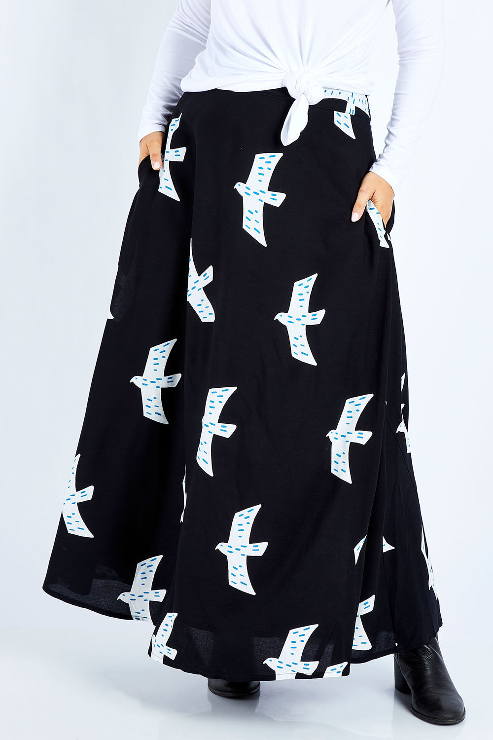 Model Jess wearing size 14 of the Rose Maxi Skirt in colour Birdflight (Black), from the front, cropped image