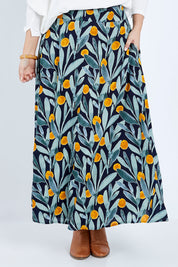 Model Jess wearing size 14 of the Rose Maxi Skirt in colour Wattle (Blue), from the front, cropped image