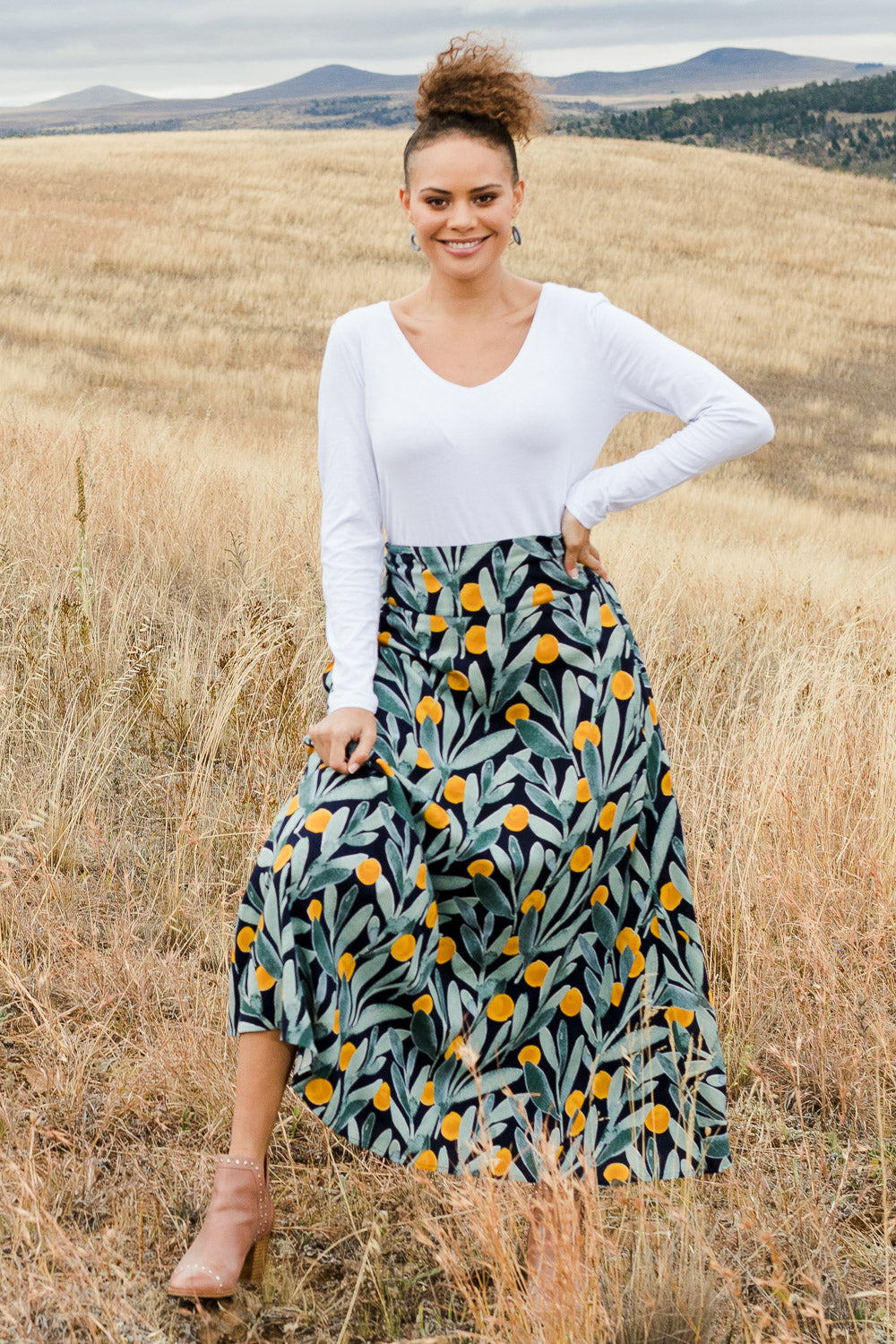 Model Lala wearing size 10 of the Rose Maxi Skirt in colour Wattle (Blue), from the front, showing the whole outfit