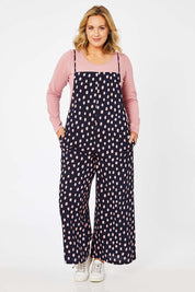 Model Jess wearing size 14 of the Tilly Overalls in colour Raindrops (Blue), from the front, showing the whole outfit