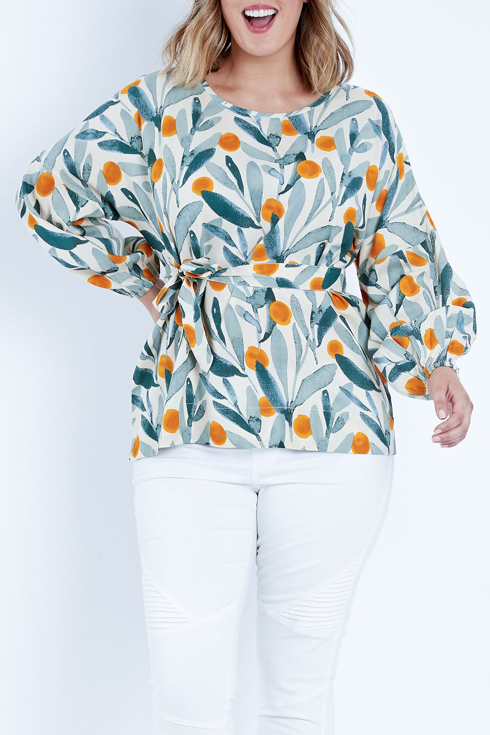 Model Jess wearing size 14 of the Felicity Blouse in colour Wattle (Green), from the front, cropped image