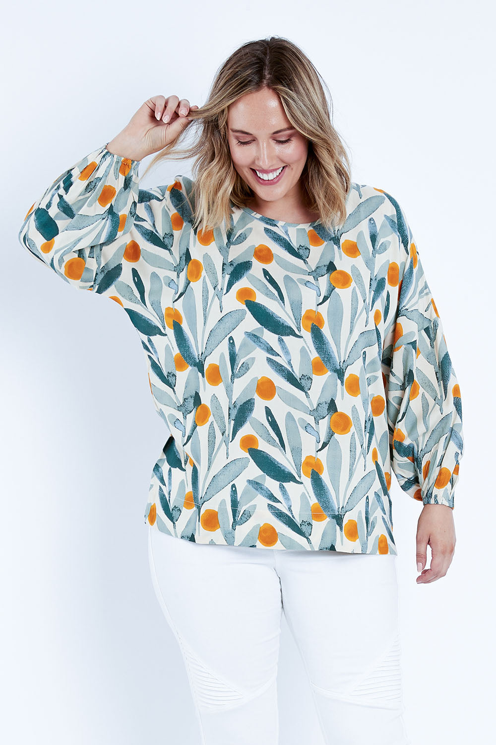 Model Jess wearing size 14 of the Felicity Blouse in colour Wattle (Green), from the front, cropped image