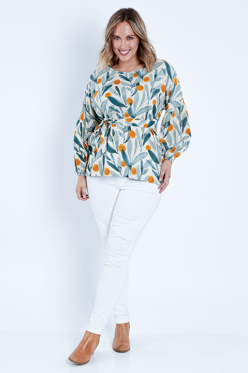 Model Jess wearing size 14 of the Felicity Blouse in colour Wattle (Green), from the front, showing the whole outfit