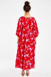 Model Courtney wearing size 10 of the Alice Gathered Dress in colour Bird (Red), from the back