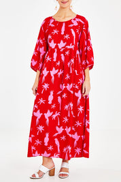 Model Courtney wearing size 10 of the Alice Gathered Dress in colour Bird (Red), from the front, cropped image