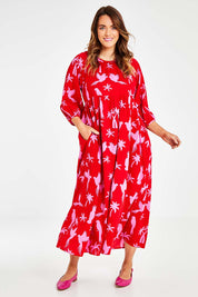 Model Laura wearing size 14 of the Alice Gathered Dress in colour Bird (Red), from the front, showing the whole outfit