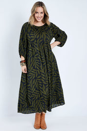 Model Jess wearing size 14 of the Alice Gathered Dress in colour Gumleaf (Black), from the front, showing the whole outfit