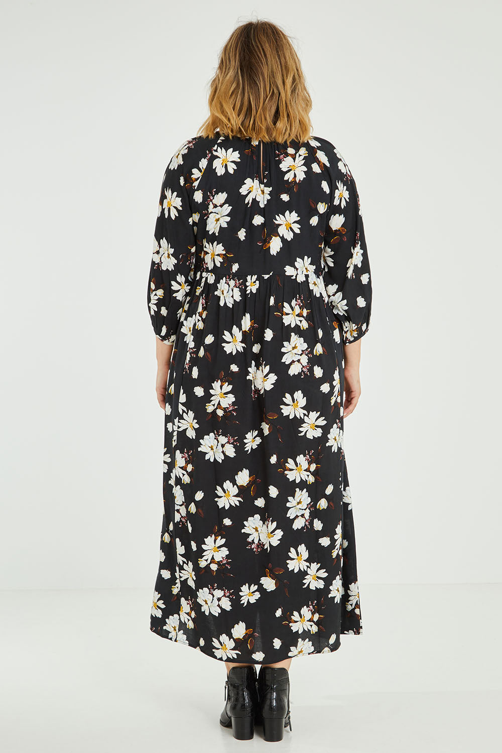 Model Jess wearing size 14 of the Alice Gathered Dress in colour Magnolia (Black), from the back