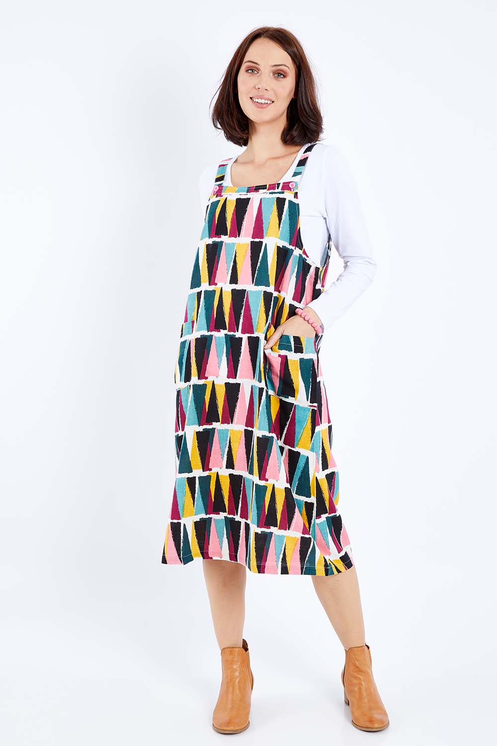 Model Andrea wearing size 10 of the Charlotte A Line Pinafore Dress in colour Mountains (Blue), from the front, showing the whole outfit