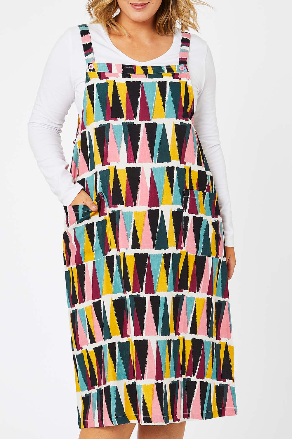 Model Jess wearing size 14 of the Charlotte A Line Pinafore Dress in colour Mountains (Blue), from the front, cropped image