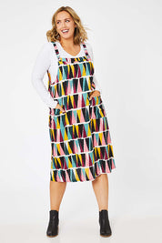 Model Jess wearing size 14 of the Charlotte A Line Pinafore Dress in colour Mountains (Blue), from the front, showing the whole outfit