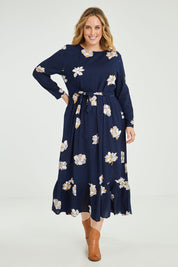 Model Jess wearing size 14 of the Lilly Long Sleeve Midi Dress in colour Camellia (Blue), from the front, showing the whole outfit