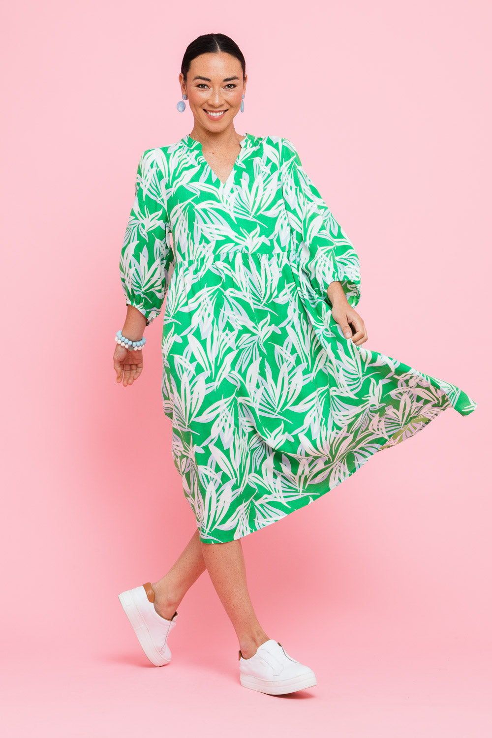 Model Katie wearing size 10 of the Chloe Dress in colour Foliage (Green), from the front, showing the whole outfit