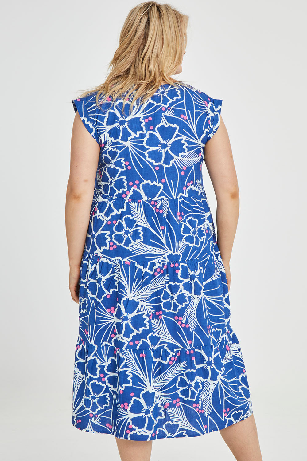 Model Keeara wearing size 16 of the Madison Tiered Dress in colour Bloom (Blue), from the back