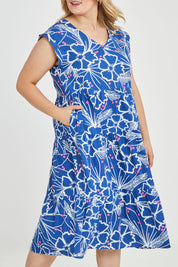 Model Keeara wearing size 16 of the Madison Tiered Dress in colour Bloom (Blue), from the front, cropped image