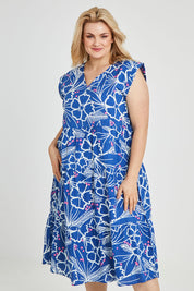 Model Keeara wearing size 16 of the Madison Tiered Dress in colour Bloom (Blue), from the front, cropped image