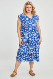 Model Keeara wearing size 16 of the Madison Tiered Dress in colour Bloom (Blue), from the front, showing the whole outfit