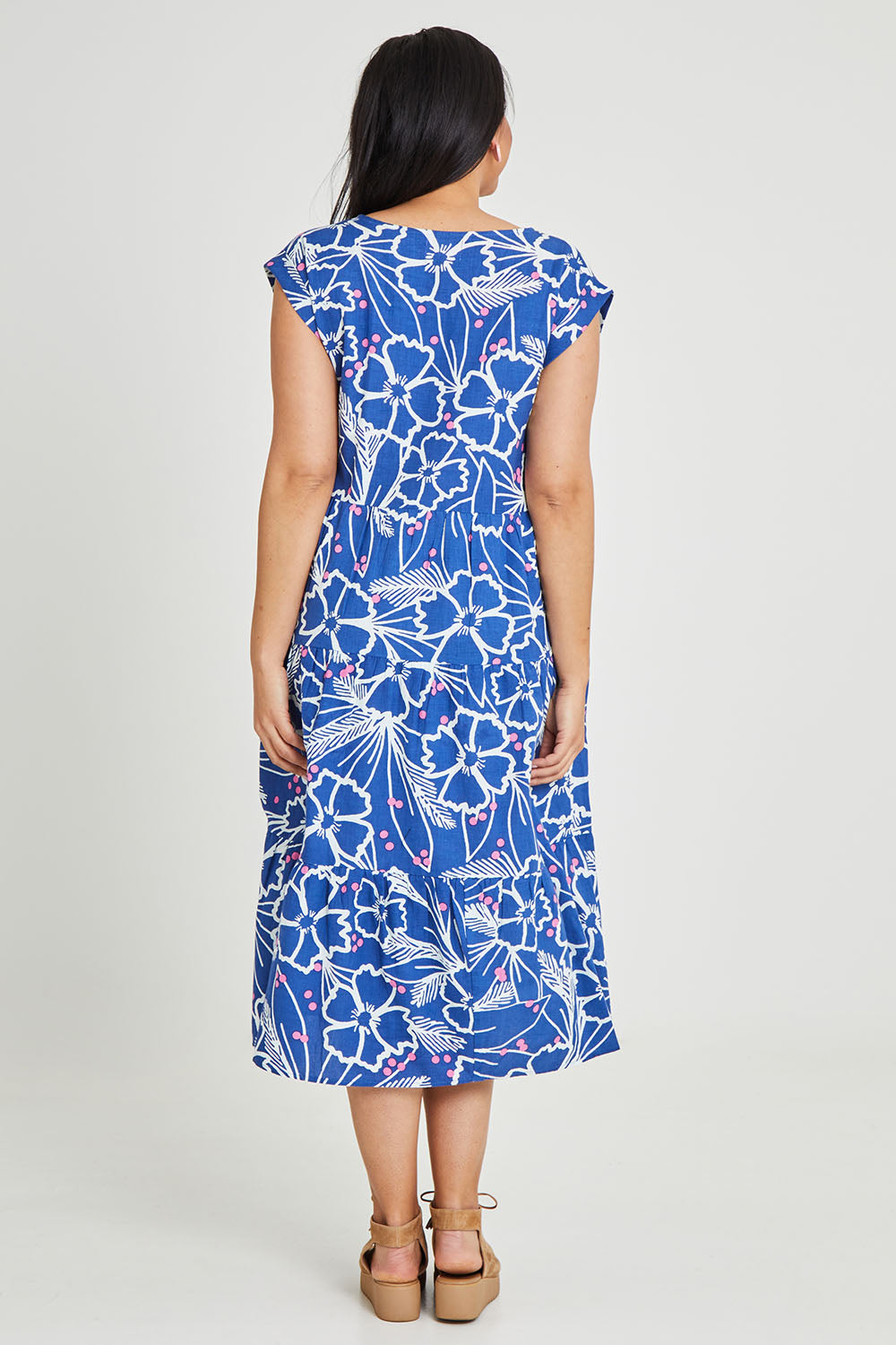Model Terri-Leigh wearing size 14 of the Madison Tiered Dress in colour Bloom (Blue), from the back
