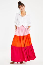 Model Courtney wearing size 10 of the Poppy Tier Skirt in colour Sunset (Pink), from the front, showing the whole outfit