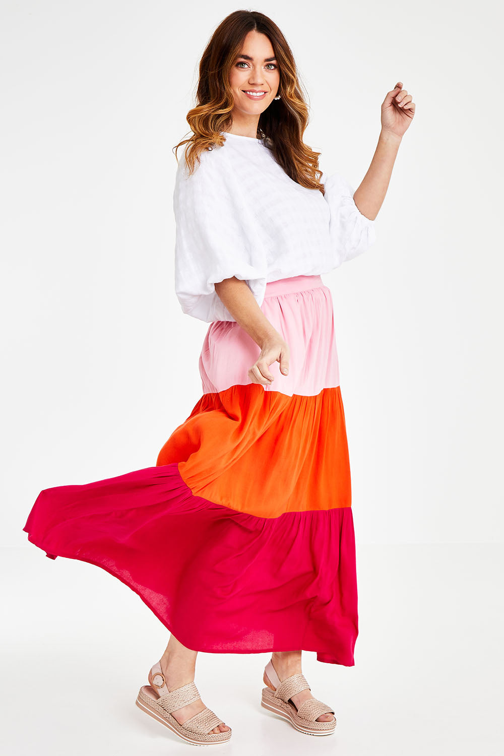 Model Laura wearing size 14 of the Poppy Tier Skirt in colour Sunset (Pink), from the front, showing the whole outfit