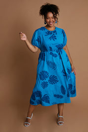 Model Alexis wearing size 16 of the Lucy Bell Sleeve Dress in colour Palm (Blue), from the front, showing the whole outfit