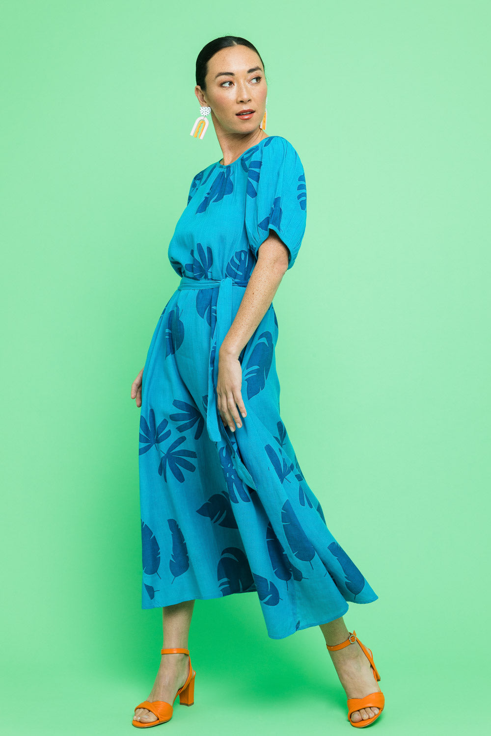 Model Katie wearing size 10 of the Lucy Bell Sleeve Dress in colour Palm (Blue), from the front, showing the whole outfit