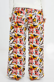 Model Laura wearing size 14 of the Stella Print Pant in colour Floral (Blue), from the back