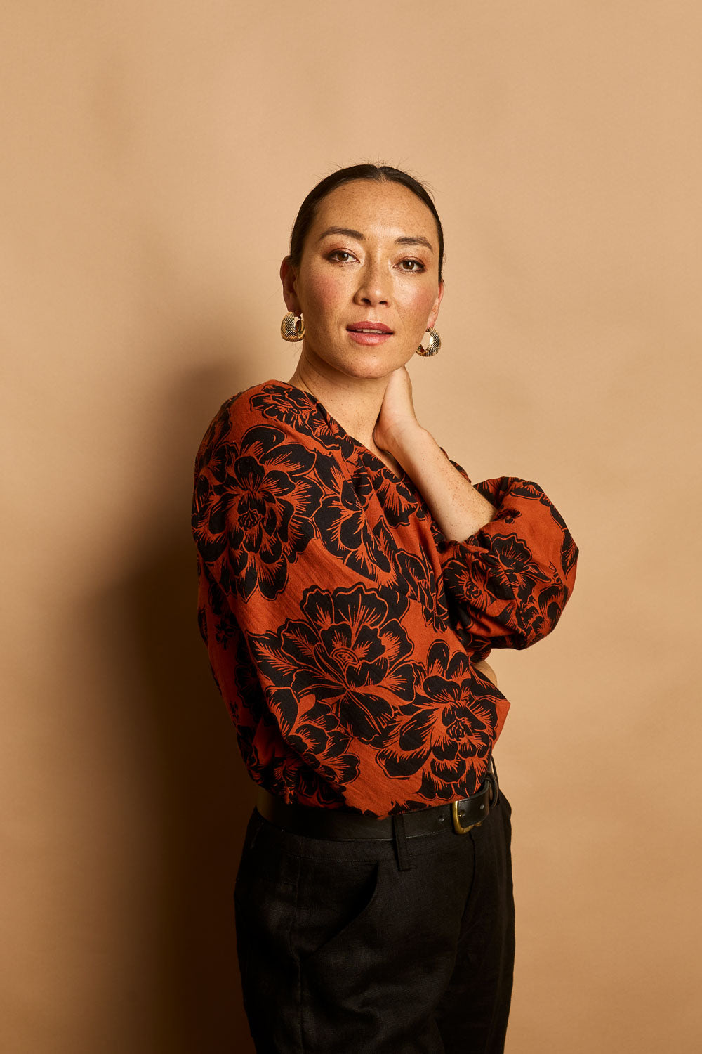 Model Katie wearing size 10 of the Jess Blouse in colour Blooming (Black), from the front, showing the whole outfit