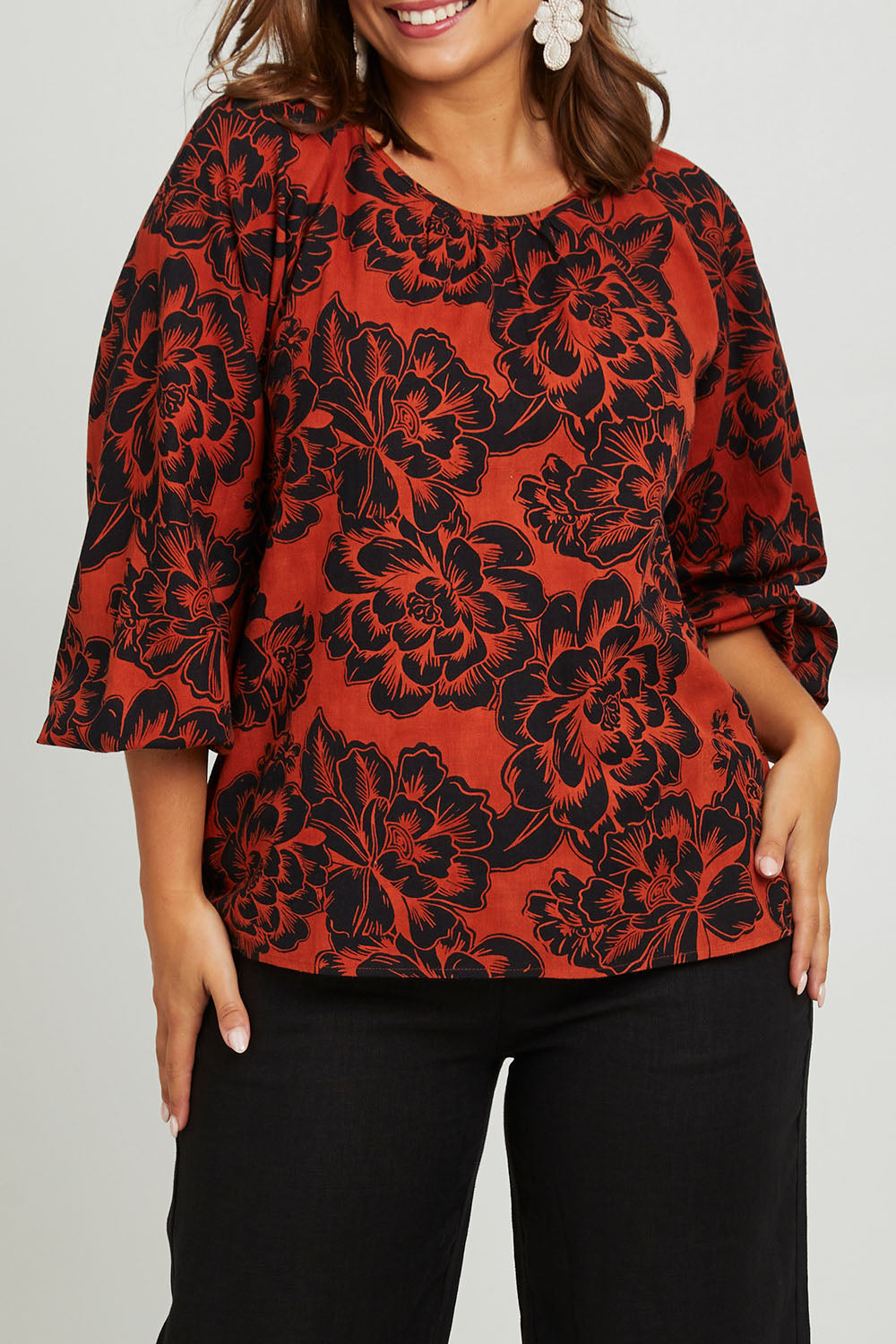 Model Monique wearing size 14 of the Jess Blouse in colour Blooming (Black), from the front, cropped image