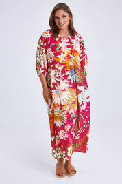 Model Monique wearing size 14 of the Isabella Dress in colour Garden (Pink), from the front, showing the whole outfit