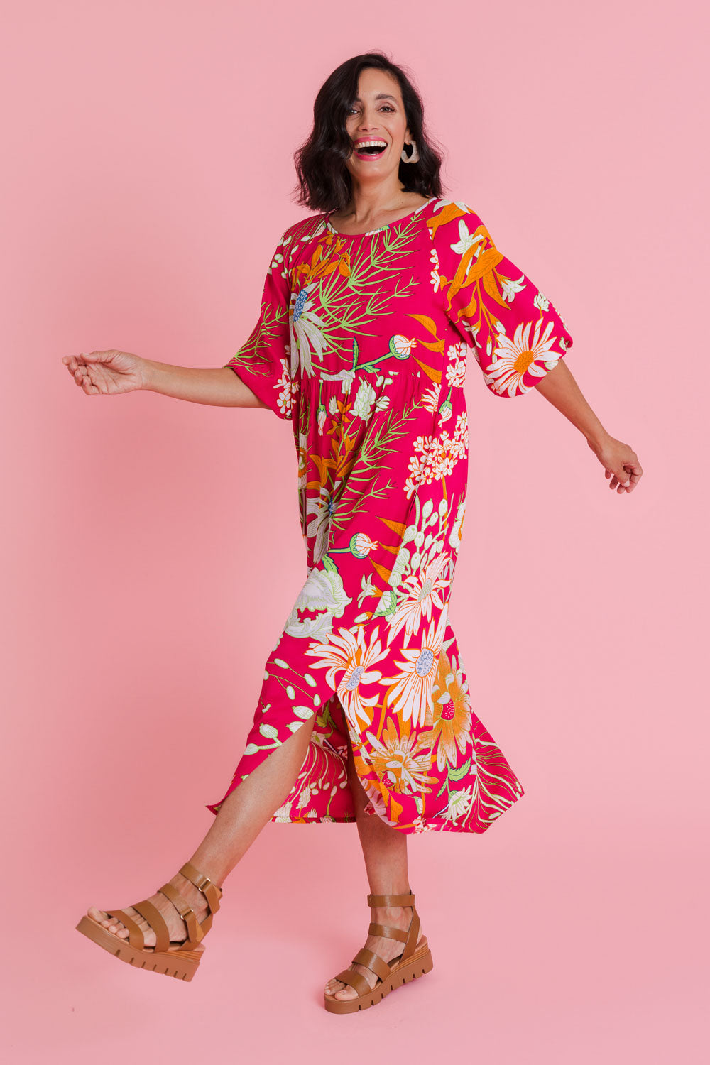Model Natalie wearing size 10 of the Isabella Dress in colour Garden (Pink), from the front, showing the whole outfit