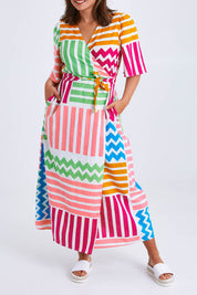 Model Monique wearing size 14 of the Ginerva Wrap Dress in colour Patchwork (White), from the front, cropped image