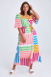 Model Monique wearing size 14 of the Ginerva Wrap Dress in colour Patchwork (White), from the front, showing the whole outfit