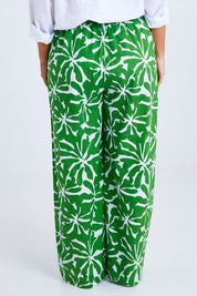 Model Monique wearing size 14 of the Silvia Print Pant in colour Zinnia (Green), from the back