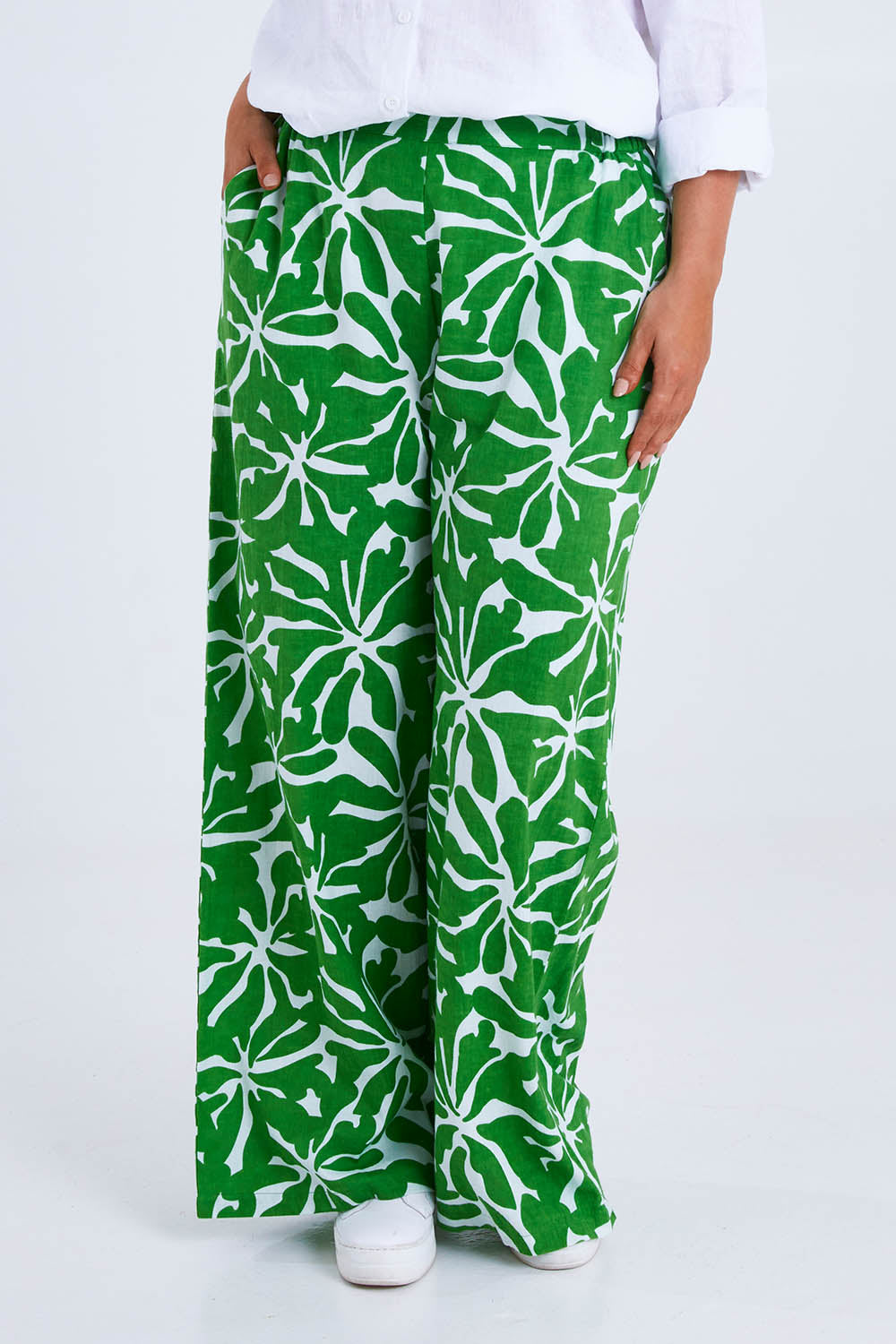 Model Monique wearing size 14 of the Silvia Print Pant in colour Zinnia (Green), from the front, cropped image