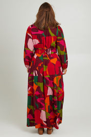 Model Monique wearing size 14 of the Gabbie Maxi Dress in colour Marble (Red), from the back