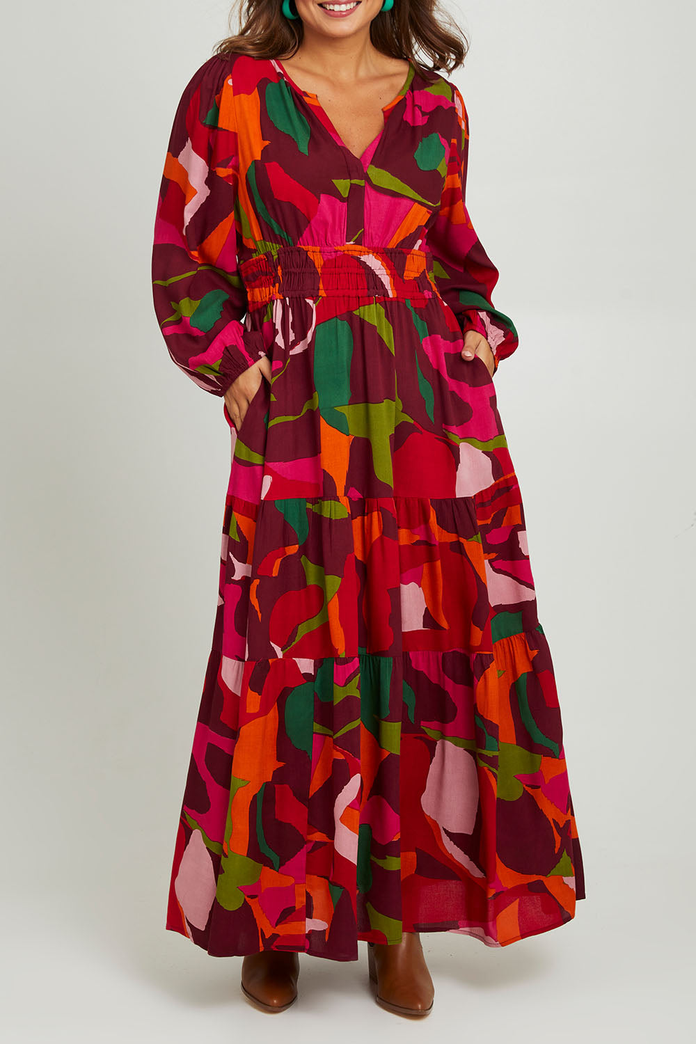 Model Monique wearing size 14 of the Gabbie Maxi Dress in colour Marble (Red), from the front, cropped image