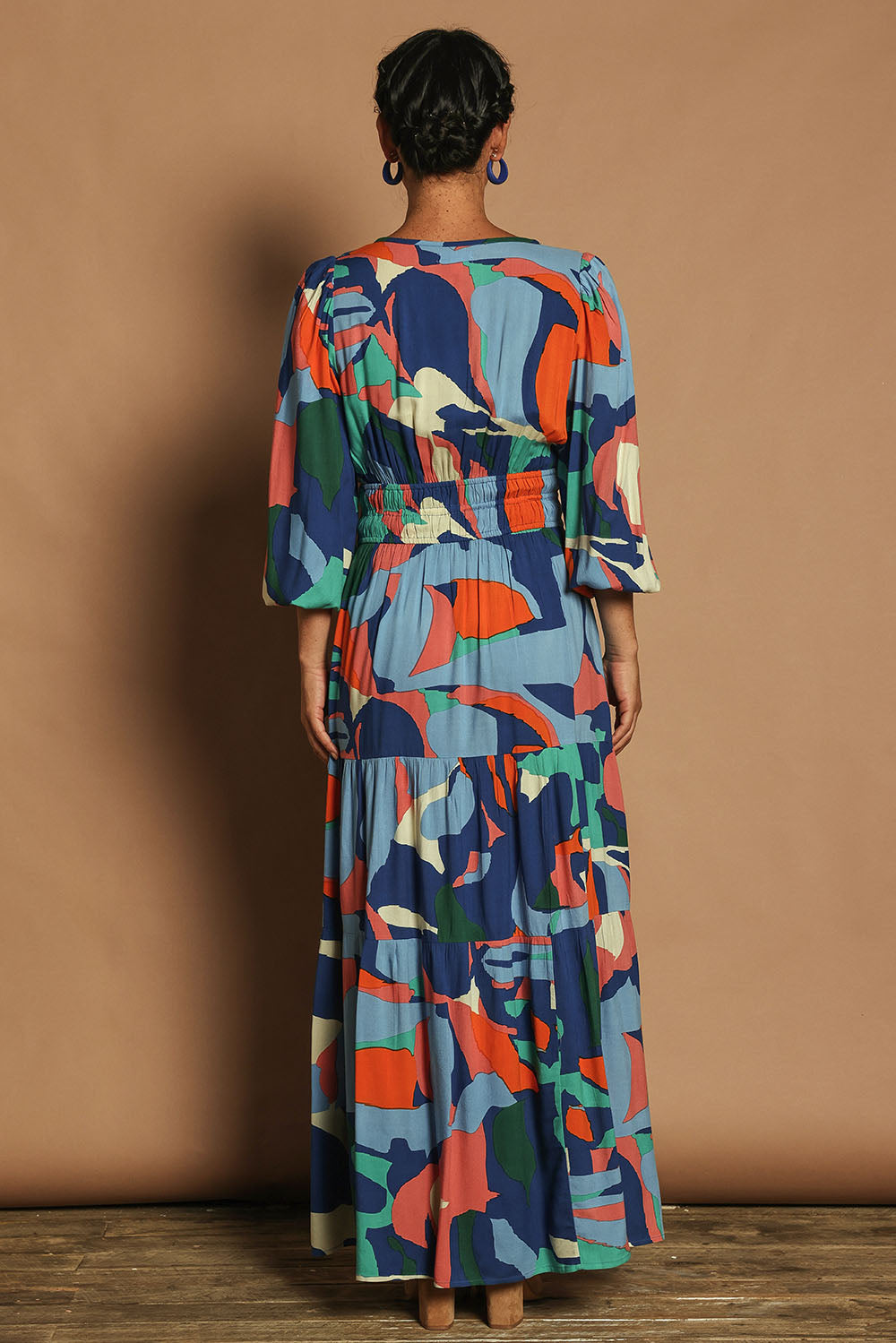 Model Katie wearing size 10 of the Gabbie Maxi Dress in colour Marble (Blue), from the back